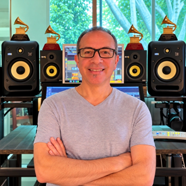 Javier Garza in his studio with Grammy Awards and mixing monitors